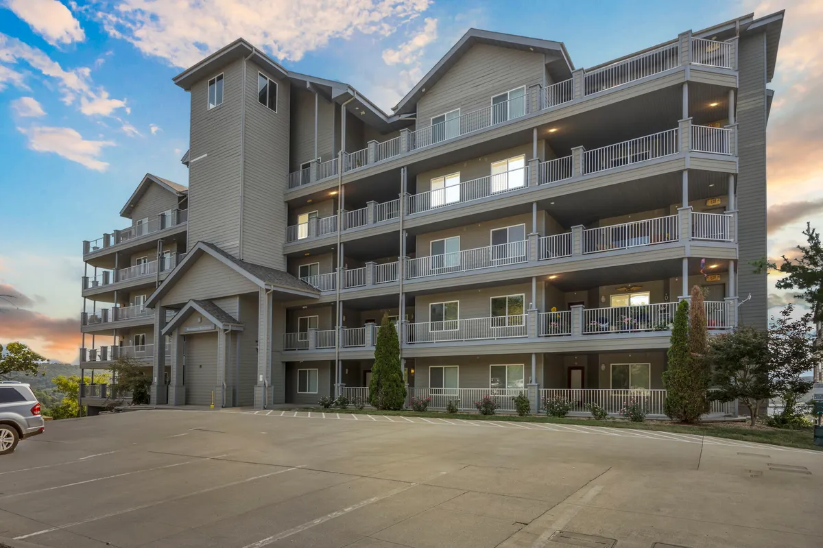 An exterior angle of the building’s architecture, balconies, and landscaped areas. The image captures the welcoming design of the property, suggests opportunities for socializing outdoors, and highlights private balconies ideal for morning coffee or sunset watching.