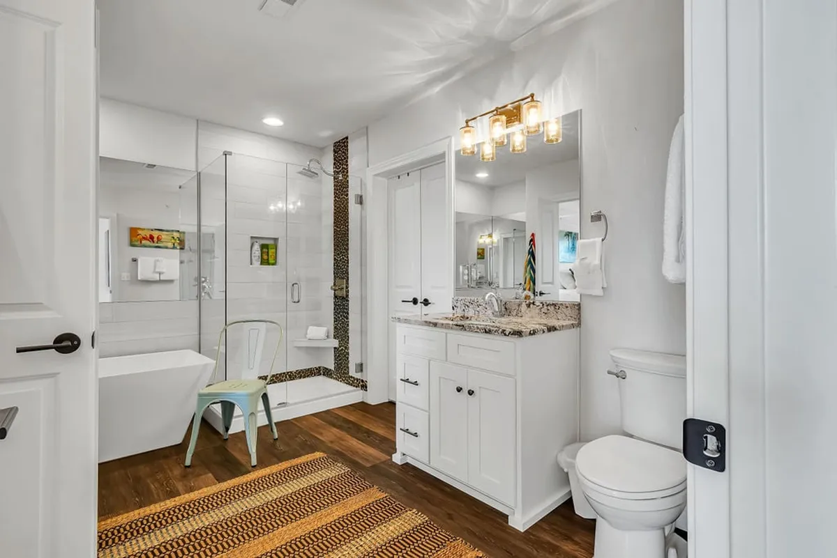 A spa-inspired ensuite bathroom with a freestanding bathtub, glass shower, modern vanity, and soft lighting. The space exudes tranquility and offers both a soothing bath and a refreshing shower experience.